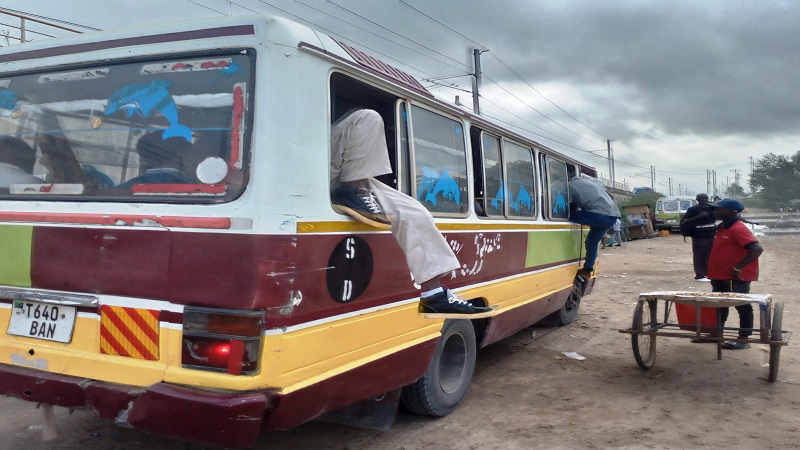  Desperate would-be passengers resort to windows as they seek to find space in a commuter bus at Gongo la Mboto in Dar es Salaam yesterday, a scene pointing to challenges with public transport in the commercial capital. 