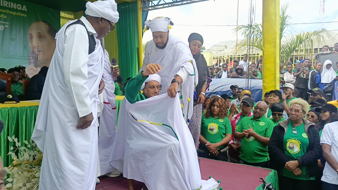 Chief Adam Abdul Sapi Mkwawa of the Hehe tribe pictured in Iringa municipality yesterday dressing CCM National Executive member Salim Abri Asas (seated) in traditional Hehe attire as a sign of special honour and recognition. 