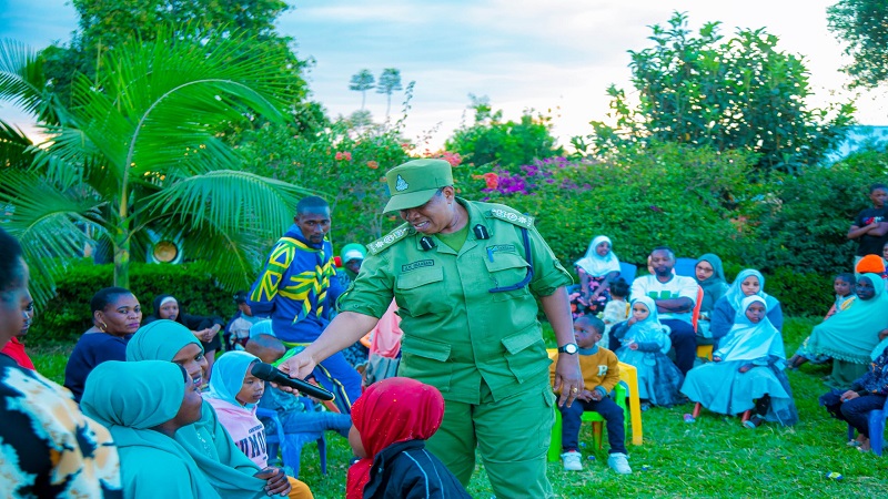  Songwe Regional Police Staff Officer Akama Shaaban pictured in Mbozi District at the weekend intermingling with children after sensitising them on ways to fight gender-based violence. 