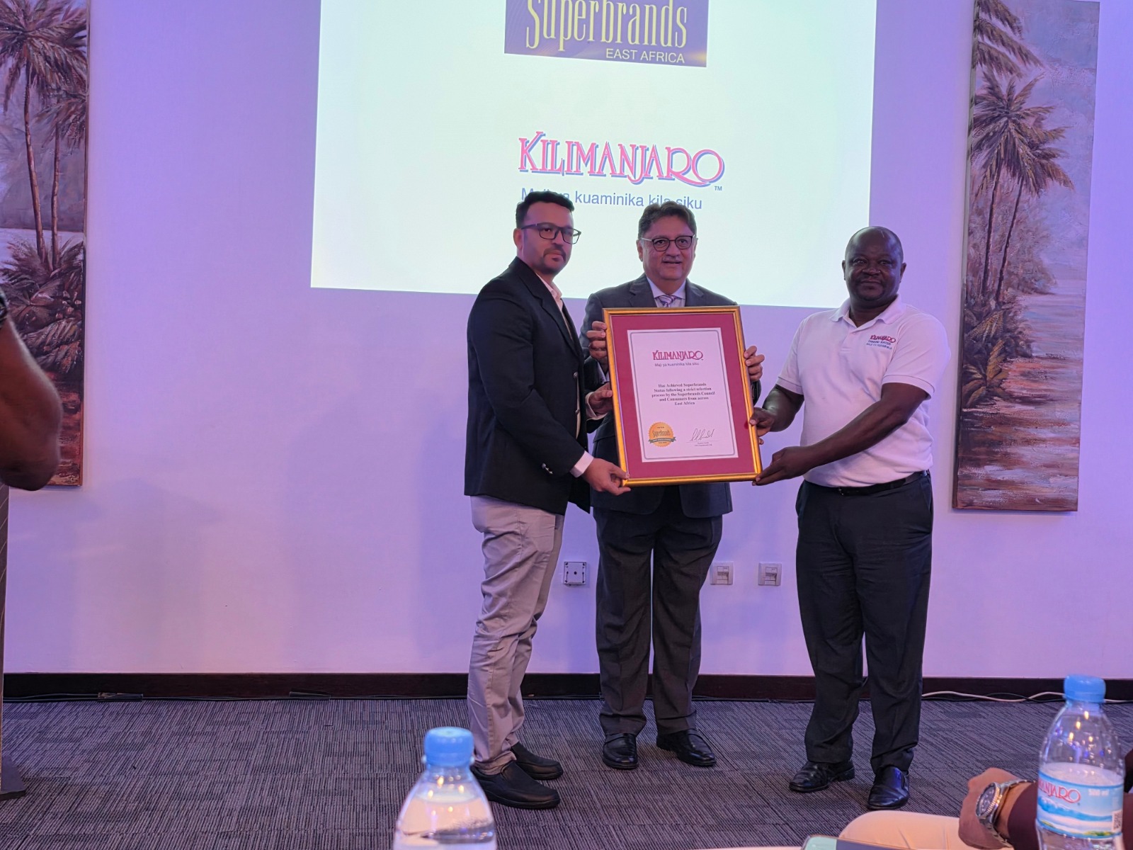 Superbrands East Africa CEO Jawad Jaffer (C) presents award to Kilimanjaro Company senior marketing officer Joseph Semali.