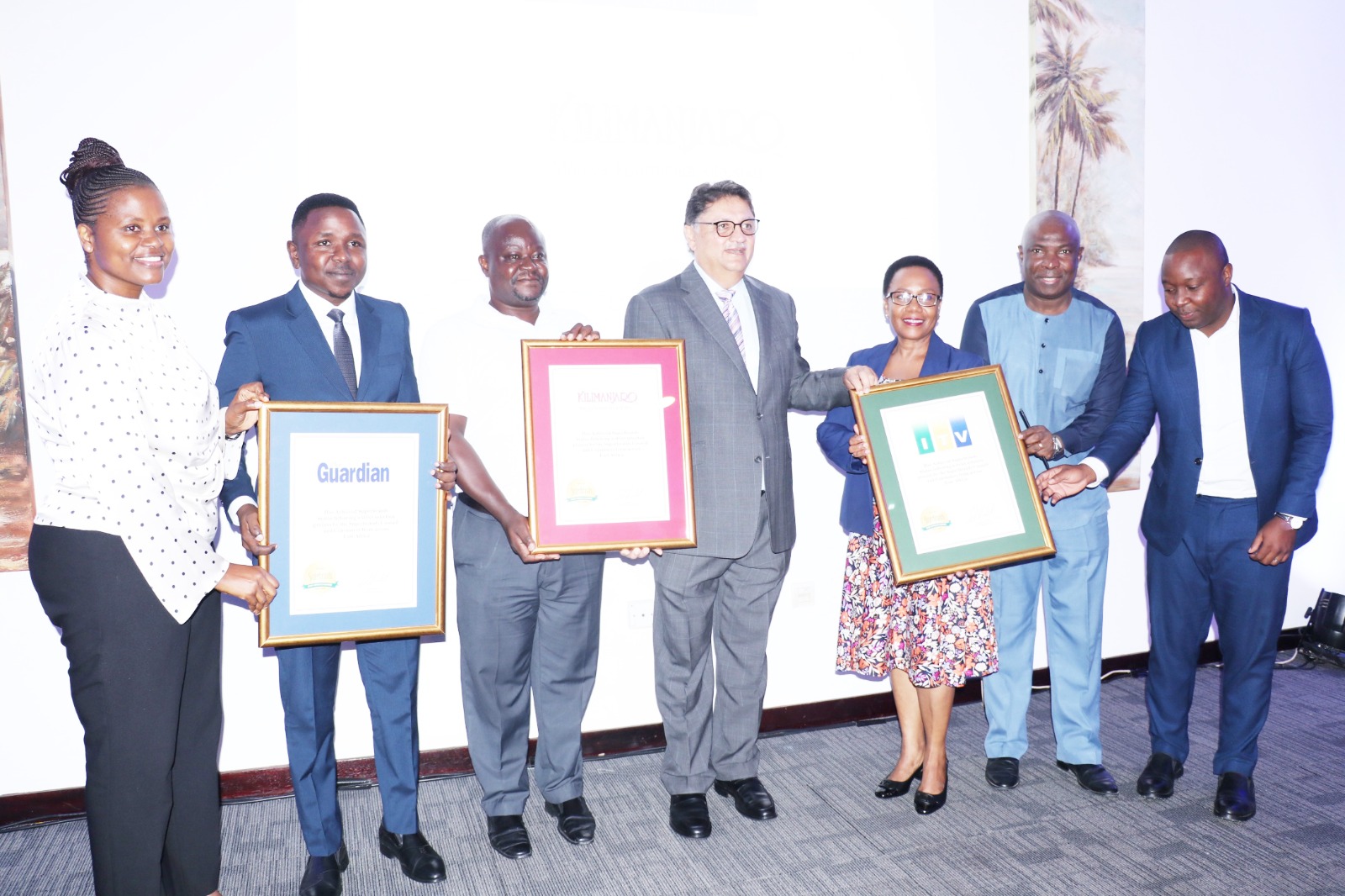 Jawad Jaffer (C), pictured with representatives of Superbrands Award winners from IPP companies.   From-L: Salome Kitomari, Jackson Paulo, Kilimanjaro Company senior marketing officer Joseph Semali, Yvonne Msemembo, ITV marketing manager Ernest Dilli.