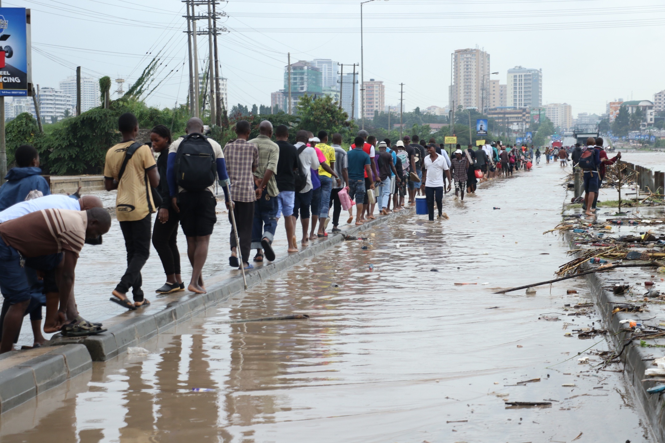 A FORCED WALK: This is to confirm that what you are seeing is evidence that nature has rendered the flood-prone Jangwani Valley stretch of Dar es Salaam’s strategic Morogoro Road impassable save for people feeling compelled to cover the full distance.