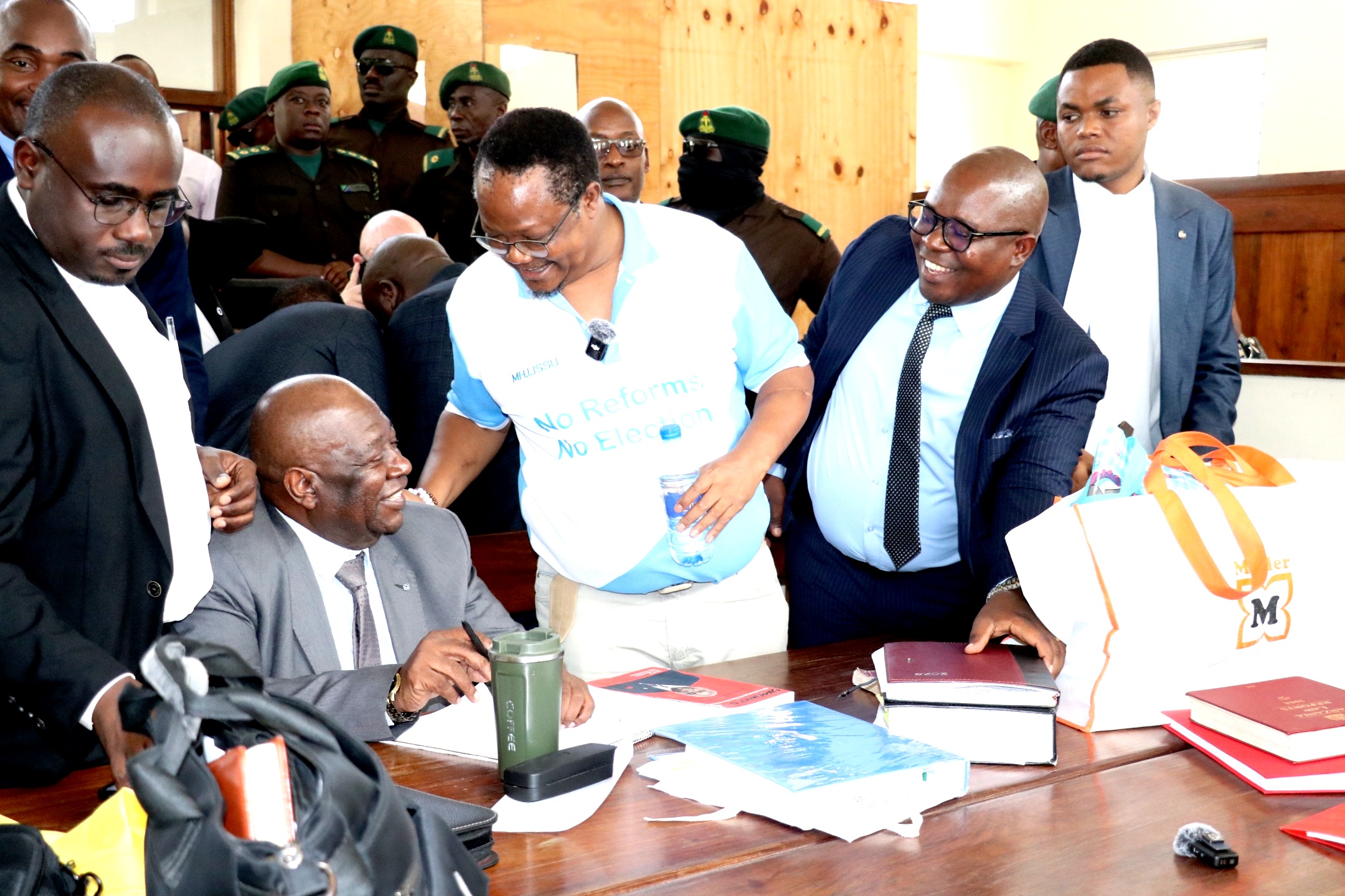 Opposition Chadema national Chairman Tundu Lissu (C, in specs) shares a light moment with his lawyers yesterday. It was during recess at the Kisutu Resident Magistrate’s Court in Dar es Salaam
