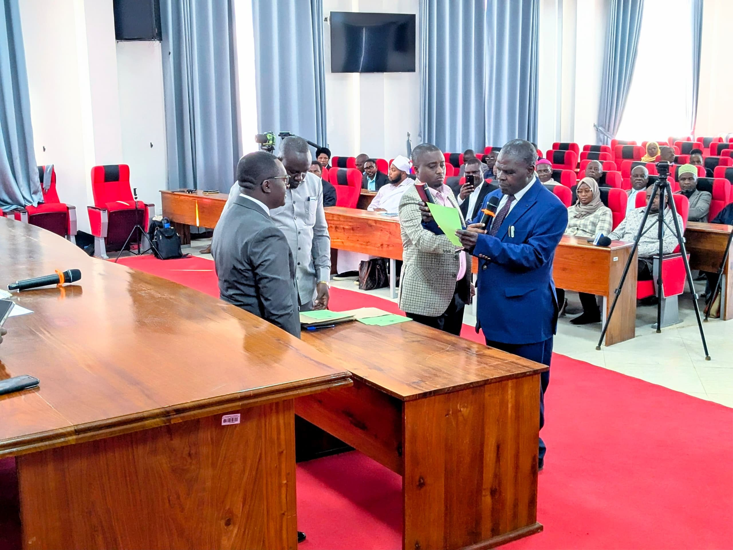 Iringa regional commissioner Kheri James (L) pictured in Iringa municipality swearing in newly appointed district commissioners for Iringa and Kilolo. 