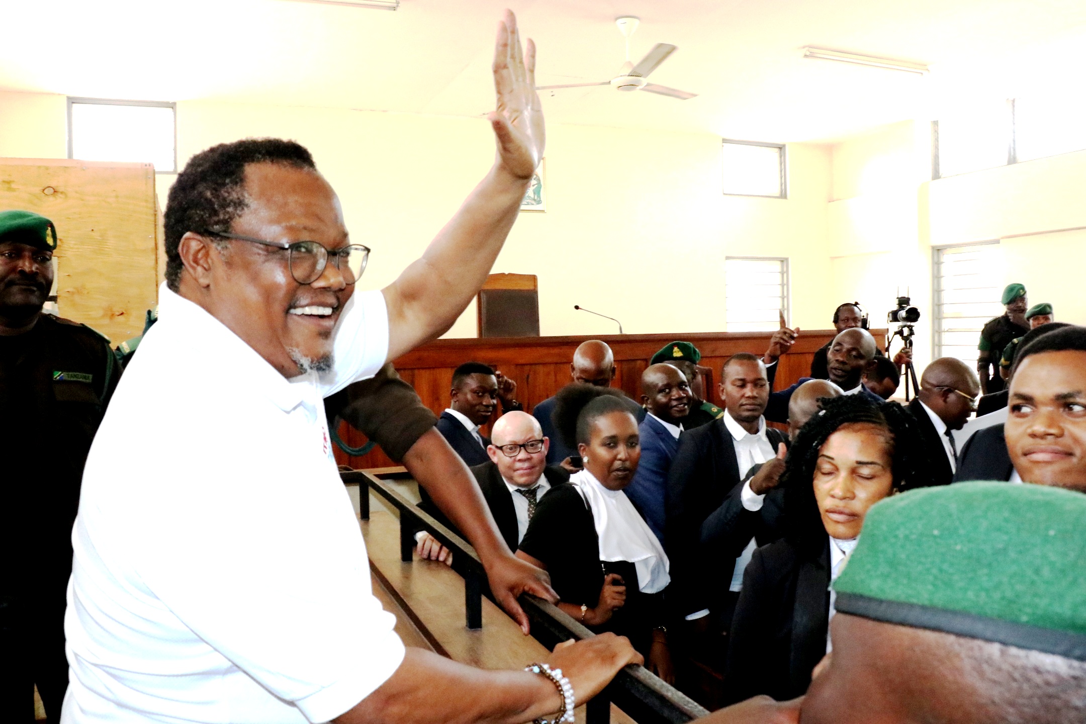 Chadema national Chairman Tundu Lissu waves presumably to members and supporters of the opposition party who were at the Kisutu Resident Magistrate’s Court in Dar es Salaam yesterday in connection with the hearing of the treason and incitement cases 
