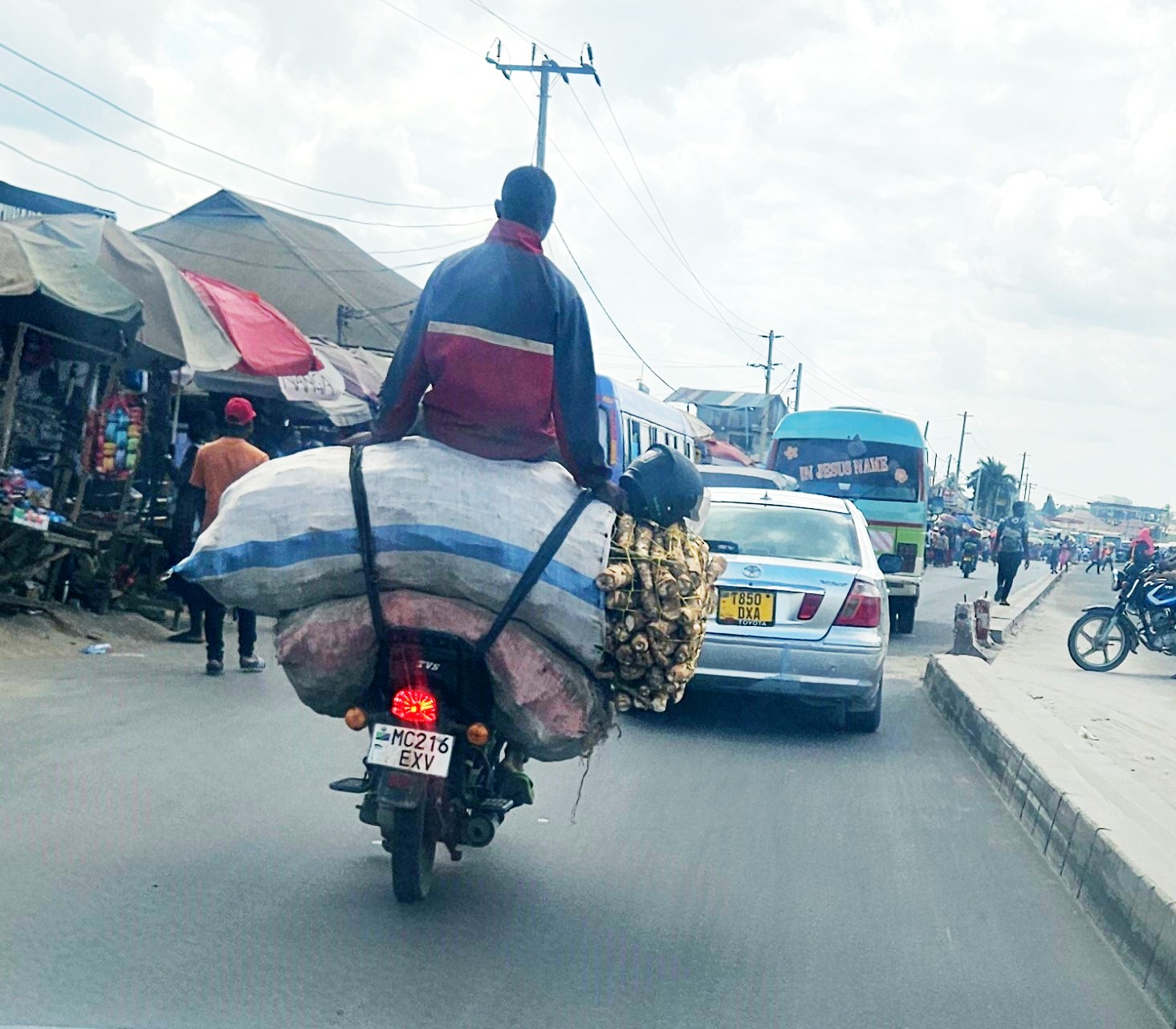   A cassava vendor sits ‘perched’ spectacularly atop his ‘cargo’ yesterday while riding a motorcycle from Kisarawe District in Coast Region headed for Dar es Salaam’s Buguruni mixed-goods market. 