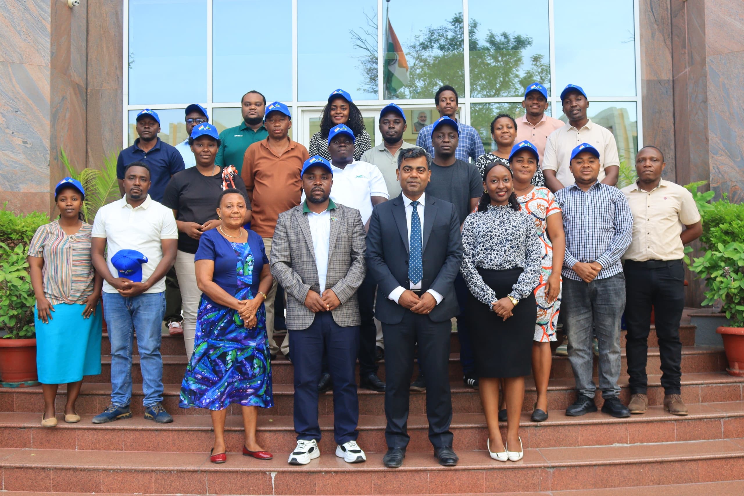 ******************  Rajnish Kumar (in tie), Head of Chancery at the Indian High Commission in Tanzania, pictured in Dar es Salaam yesterday with Tanzania Electric Supply Company (Tanesco) employees lined up for training in India under the Indian govt prg.