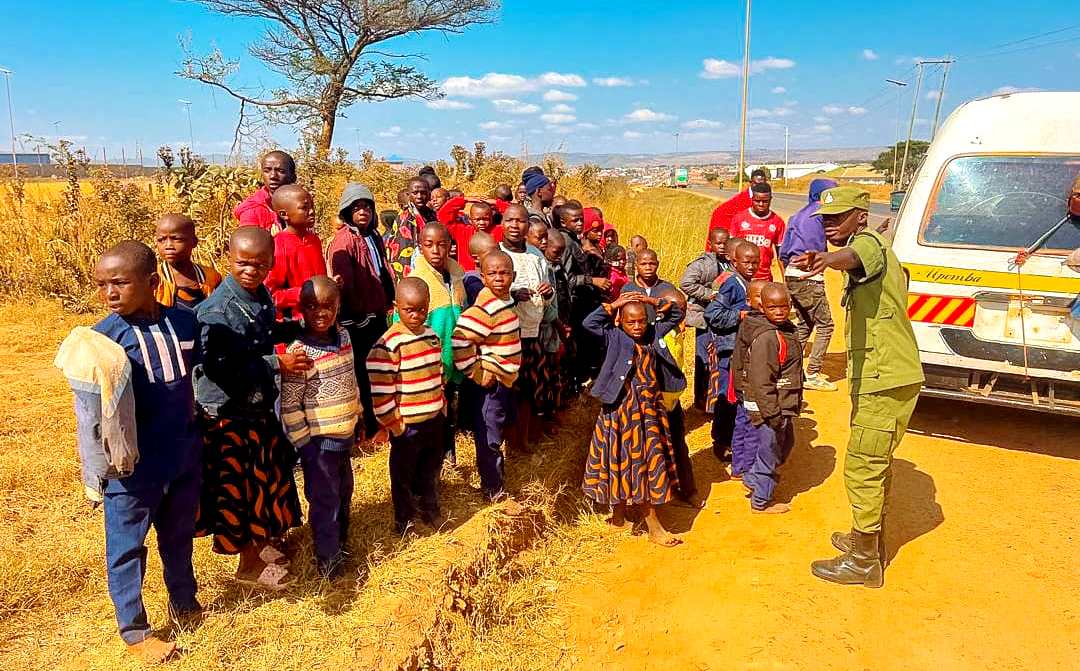 Inspector of Police Nelson Mwinuka pictured yesterday at an impromptu vehicle inspection spot at Chimbuya in Mbozi District, Songwe Region, sensitising children who were aboard an overcrowded microbus on road safety. 